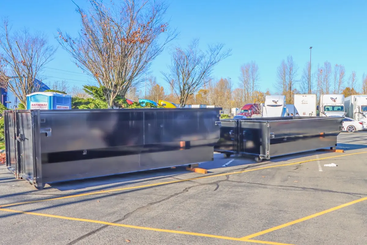 Professional dumpster rental service with roll-off container on residential driveway in Port Wentworth